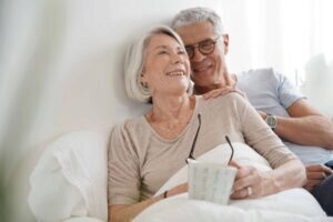 Senior couple cudding in bed