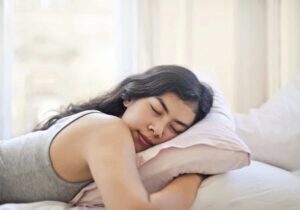 Woman lying on stomach on bed